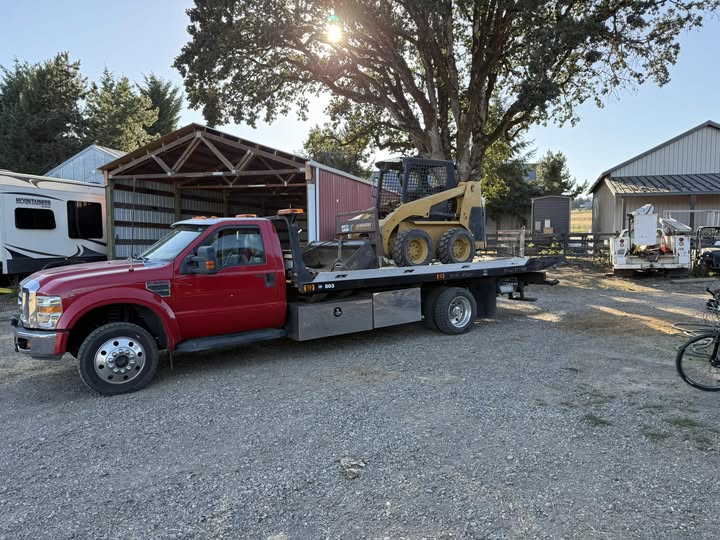 Otto Kings red flatbed tow truck at golden hour in Wilsonville Oregon